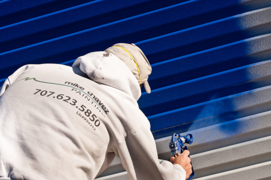 spray painting home exterior blue