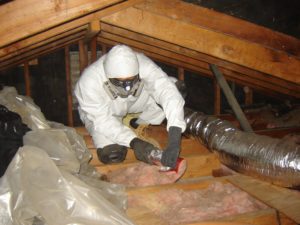 Atticare technician installing attic insulation